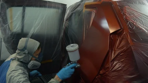 Painter paints the car in the box Stock Footage 87938529