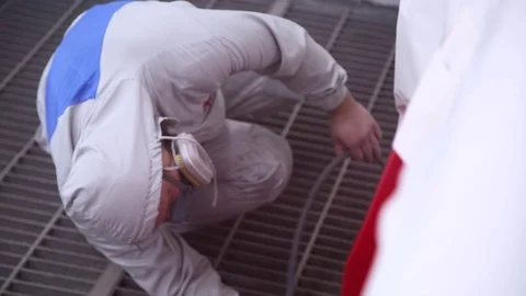 Painter paints the car in workshop Stock Footage 69885778