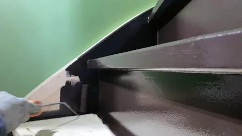 Painter paints stairs with a paint roller Stock-Footage 201959464
