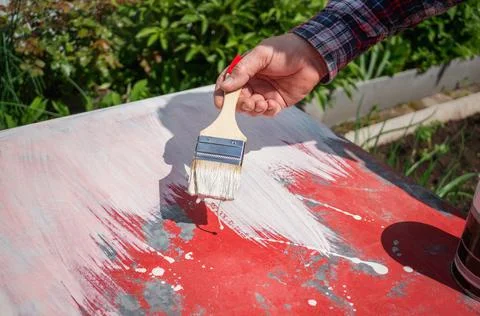 Painter paints the surface white. The image is a freshly painted white backgr Stock Photos