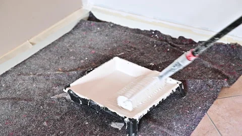 Painter paints the wall. close-up of paint roller Stock Footage 166084766