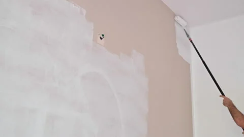 Painter paints the wall. close-up of paint roller Video stock 166176640