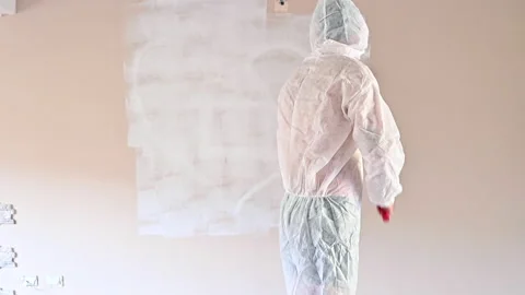 Painter paints the wall. A man paints a wall with a roller. 스톡 동영상 166084601