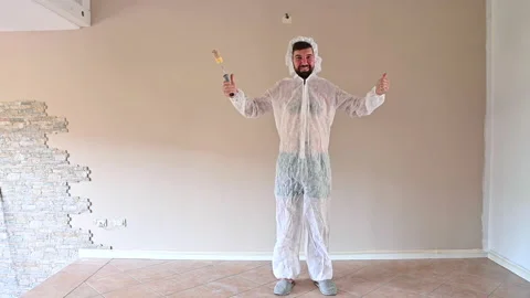 Painter paints the wall. A man paints a wall with a roller. Stock Footage 166507204