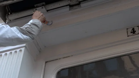 Painter paints white paint brush wall and roller Vidéo 95819655