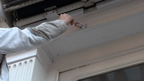 Painter paints white paint brush wall and roller Stock Footage 95820563
