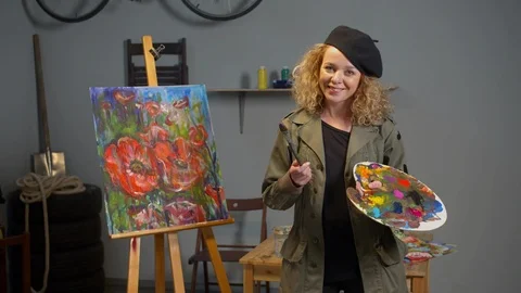 Painter with palette stands and smiles, slow motion Stock Footage 125285359