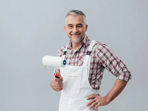 Painter posing with a paint roller Stock Photos