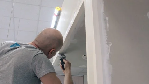 Painter putties walls using spatula preparing for painting Stock Footage 124608041