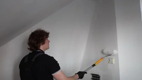 Painter renovating bright attic room Stock-Footage 335040349