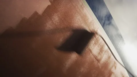 A painter repaints and protects the hull of his boat, in Switzerland Stock Footage 229707940
