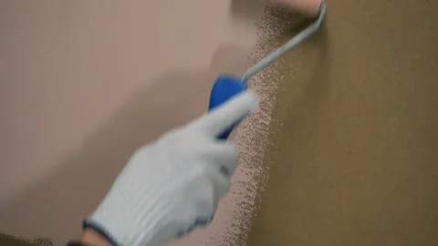 A painter repaints a surface with a roller Видео 323560650