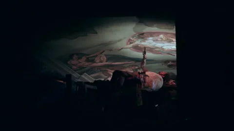 Painter restoring cathedral ceiling fresco, low light, religious mural Stock Footage 336597847