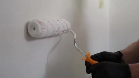 Painter rolling white paint indoors Stock Footage 335040610