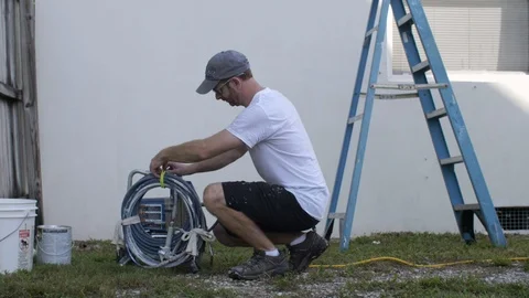 Painter Sets up Paint Gun Stock Footage 95483749