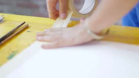 Painter setting up tape on working table closeup Video stock 59228764