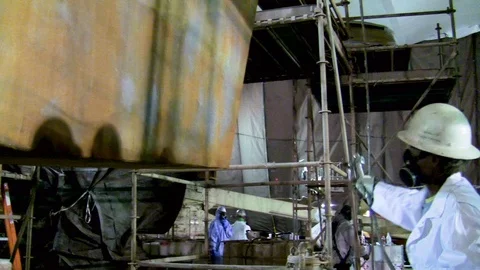 Painter spray painting interior on large industrial construction 1 Stock Footage 123724808