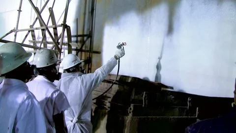Painter spray painting interior on large industrial construction 2 Stock Footage 123724821