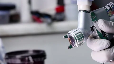 Painter Spraying Paint with Spray Gun Stock Footage 306732274
