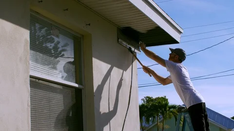 Painter Sprays Coat of Black Paint on House Stock Footage 95487723
