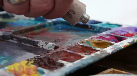 Painter squeezes paint from a tube Stock Footage 61571777