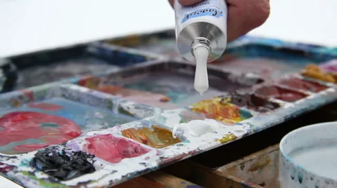 Painter squeezes paint from a tube Stock Footage 61571835