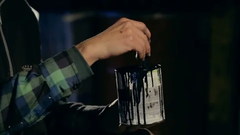 Painter Stirring a Black Paint in a Jar. Video stock 86236584
