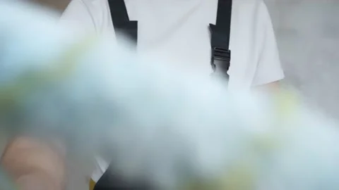 The painter stretches a blue roller to the camera and paints over the screen Stock Footage 144570048