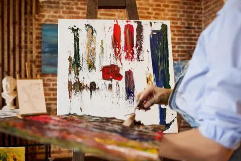 Painter at the studio creating abstract picture on canvas using oil paintings Stock Photos
