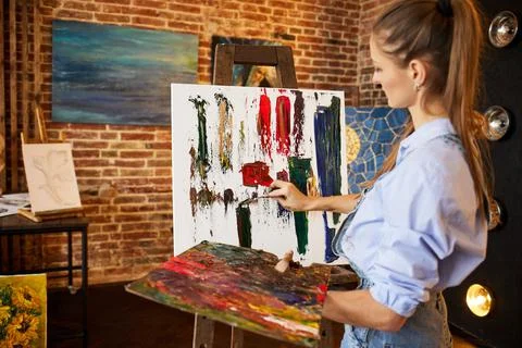 Painter at the studio creating abstract picture on canvas using oil paintings Stock Photos