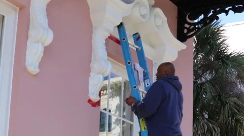 Painter Taping off Exterior Window in Historic Charleston, SC Stock Footage 45630184