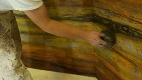 Painter uses sponge to create creative paint look on wood wall  스톡 동영상 125635317