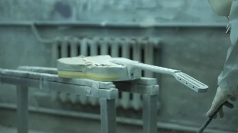 Painter using a paint sprayer for a guitar and creates props for the filming Stock Footage 73910185