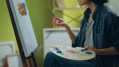 A painter with very delicate hands is mi... | Stock Video | Pond5