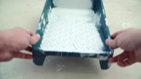 Painter Worker is Preparing to Paint the Walls with a Roller Stock Footage 125708830