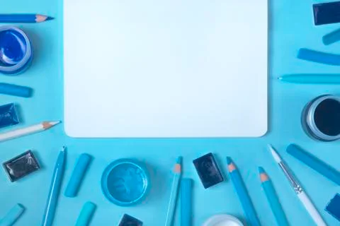 Painter working desk on blue background Stock Photos