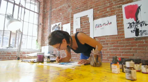 Painter working in her beautiful NYC studio wide slide Stock Footage 59243058
