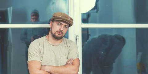 Painter working with paint roller and brushes to paint the room Stock Photos