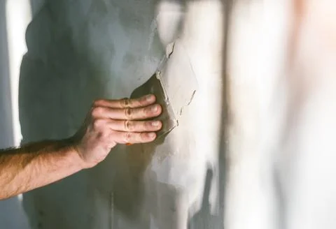 Painter working with paint roller and brushes to paint the room Stock Photos