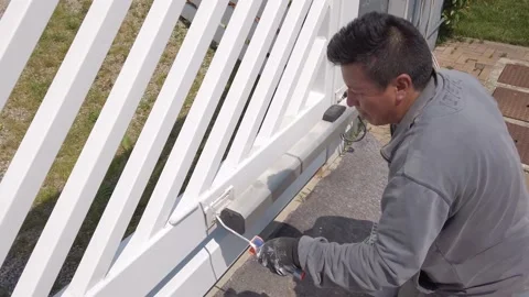 Painter Working at the Private White Gate Outdoors Stock Footage 131264342