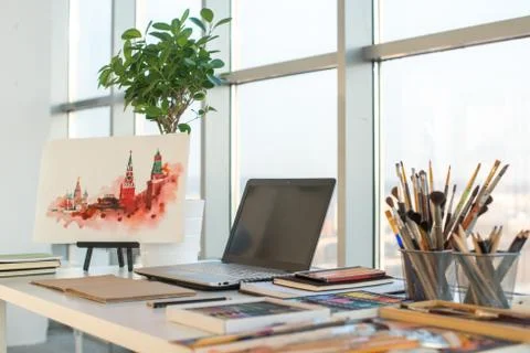 Painter workplace in order side view. Designer desk with drawing equipment. Home Fotos Stock