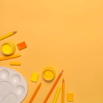 Painter workplace with tools on orange background Stock Photos