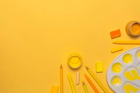 Painter workplace with tools on yellow background Stock Photos