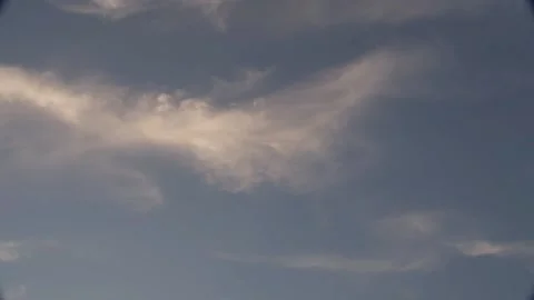Painterly clouds against a gray blue sky Stock Footage 145849256