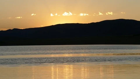 A painterly sunset. The coast of the lake and the hills. Stock Footage 80091066
