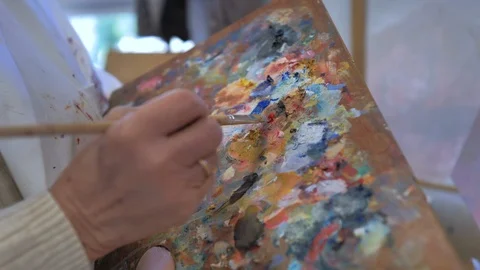 Painter's hand using color palette gh5 Stock Footage 124369217
