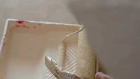  painter's hands passing the roller to whitewash the walls Stock Footage 130696499