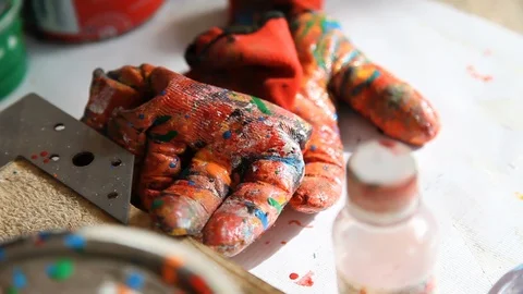 Painter's set: rubber gloves covered in colorful paints Stock-Footage 124519023