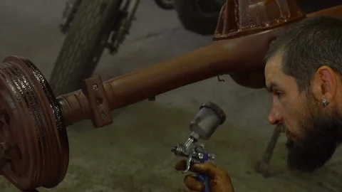 Painting auto parts using a sprayer Stock Footage 80930267