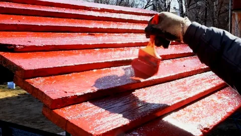 Painting with a brush to paint the elements of the playground in red Video stock 129094896